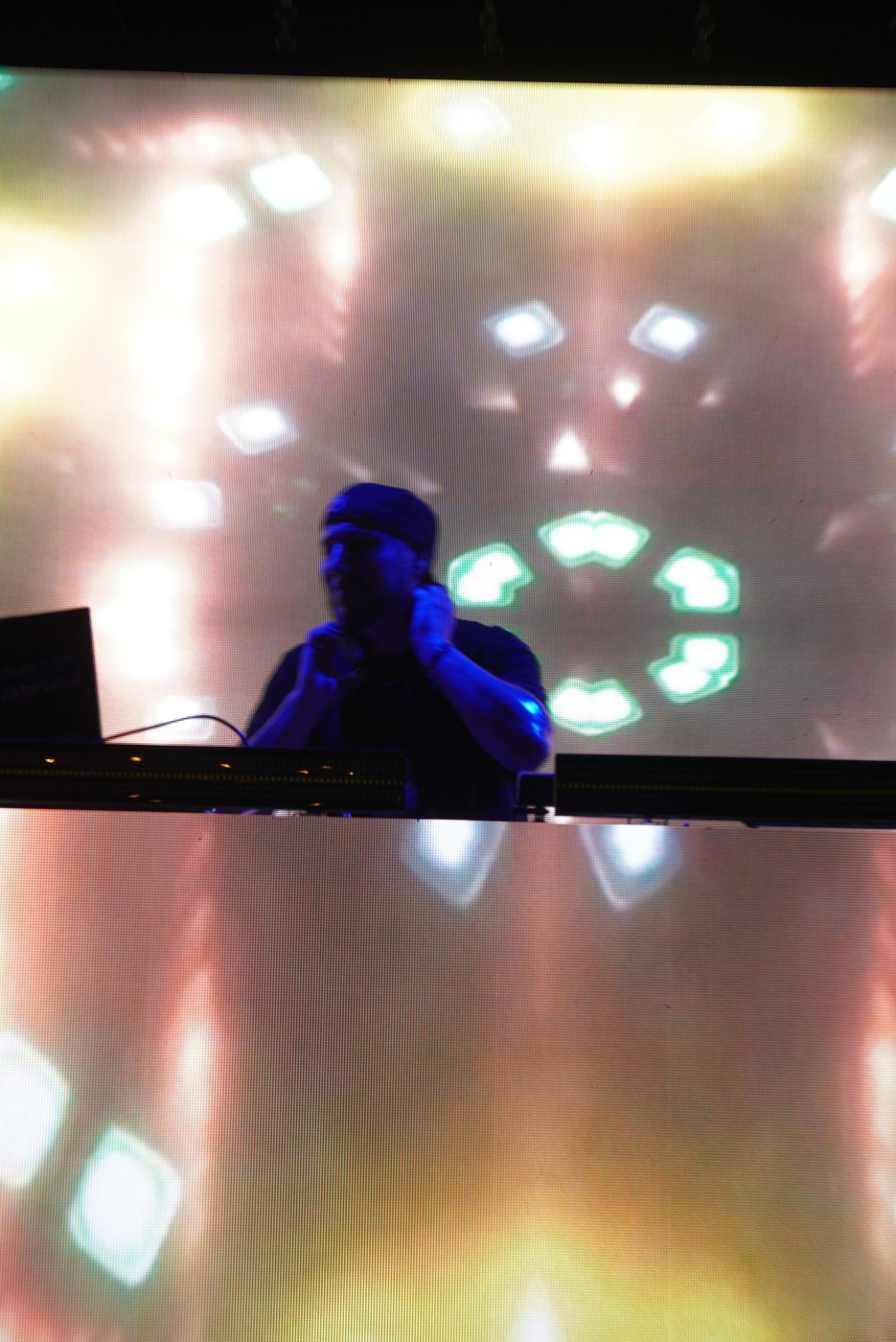 The Bar A DJ booth against a gold and white LED tunnel visual