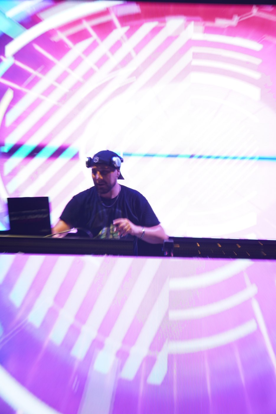 The Bar A DJ booth with pink concentric-circle LED visuals