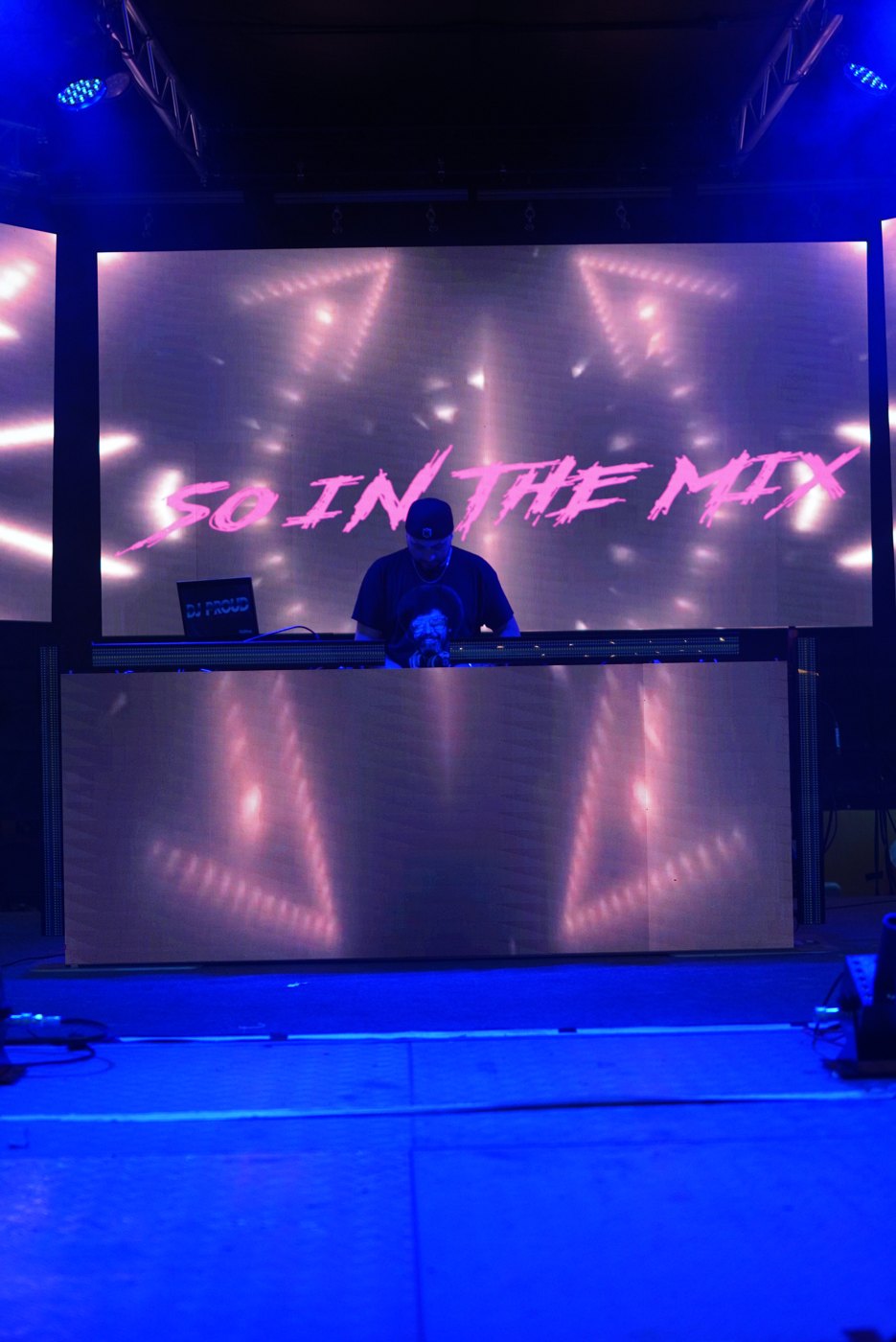 The DJ booth at Bar A with the SO IN THE MIX LED wall glowing blue