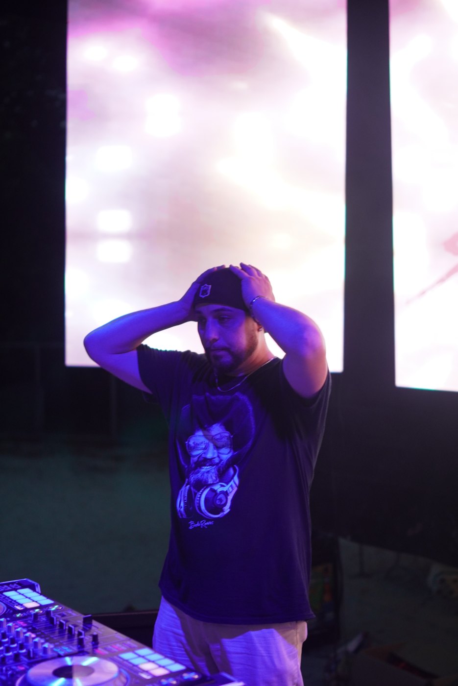 Candid shot of Barry at the decks at Bar A, hands on his head