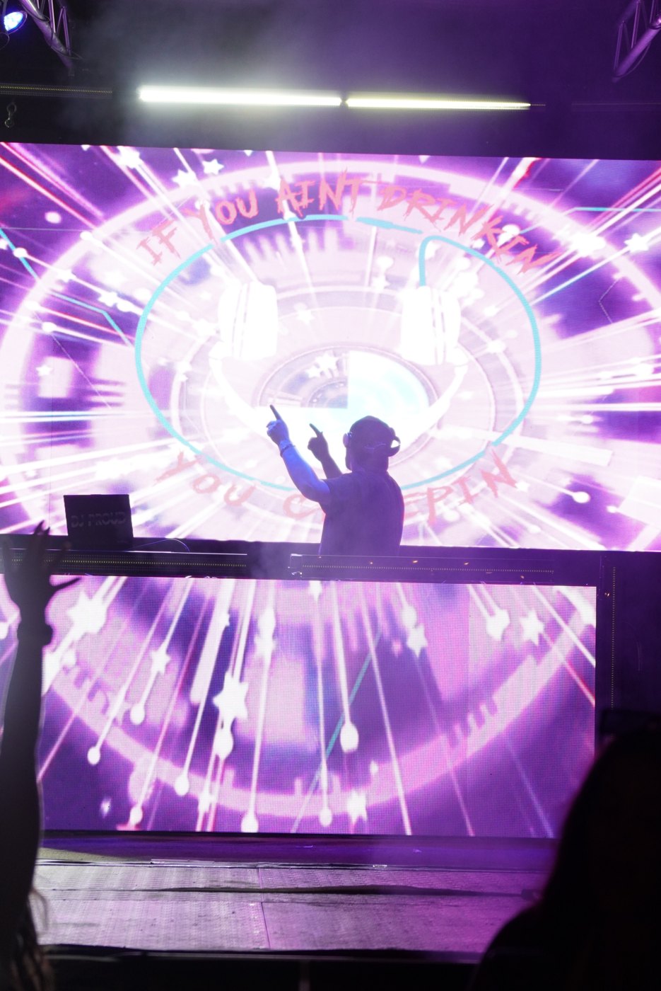 Barry silhouetted against a purple spiral LED visual at Bar A