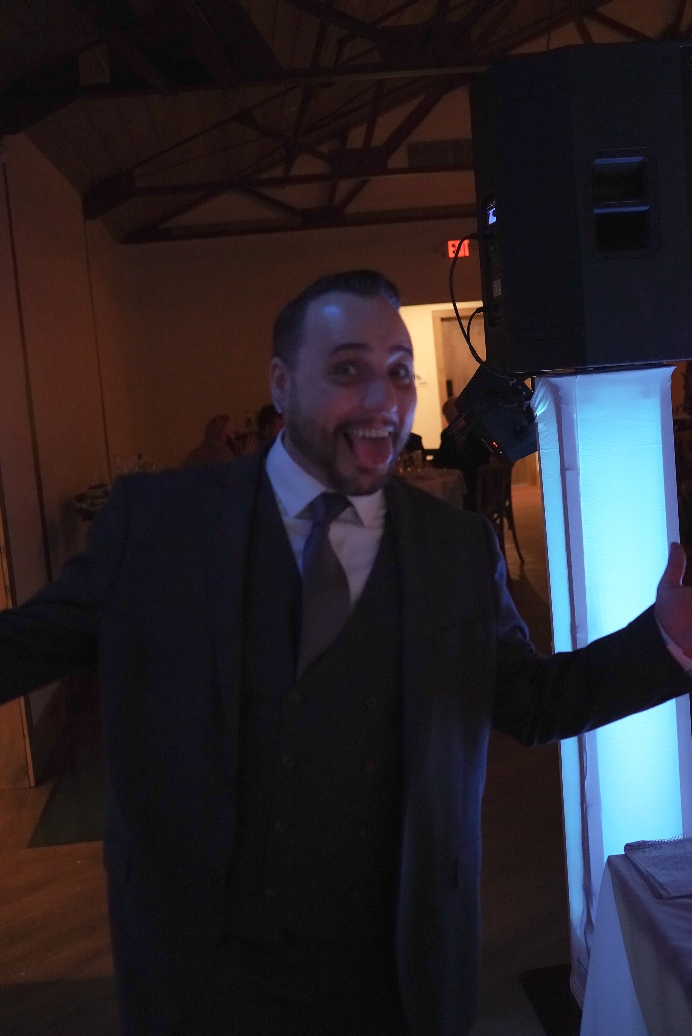 Barry smiling with arms open at the DJ booth, ready for the night