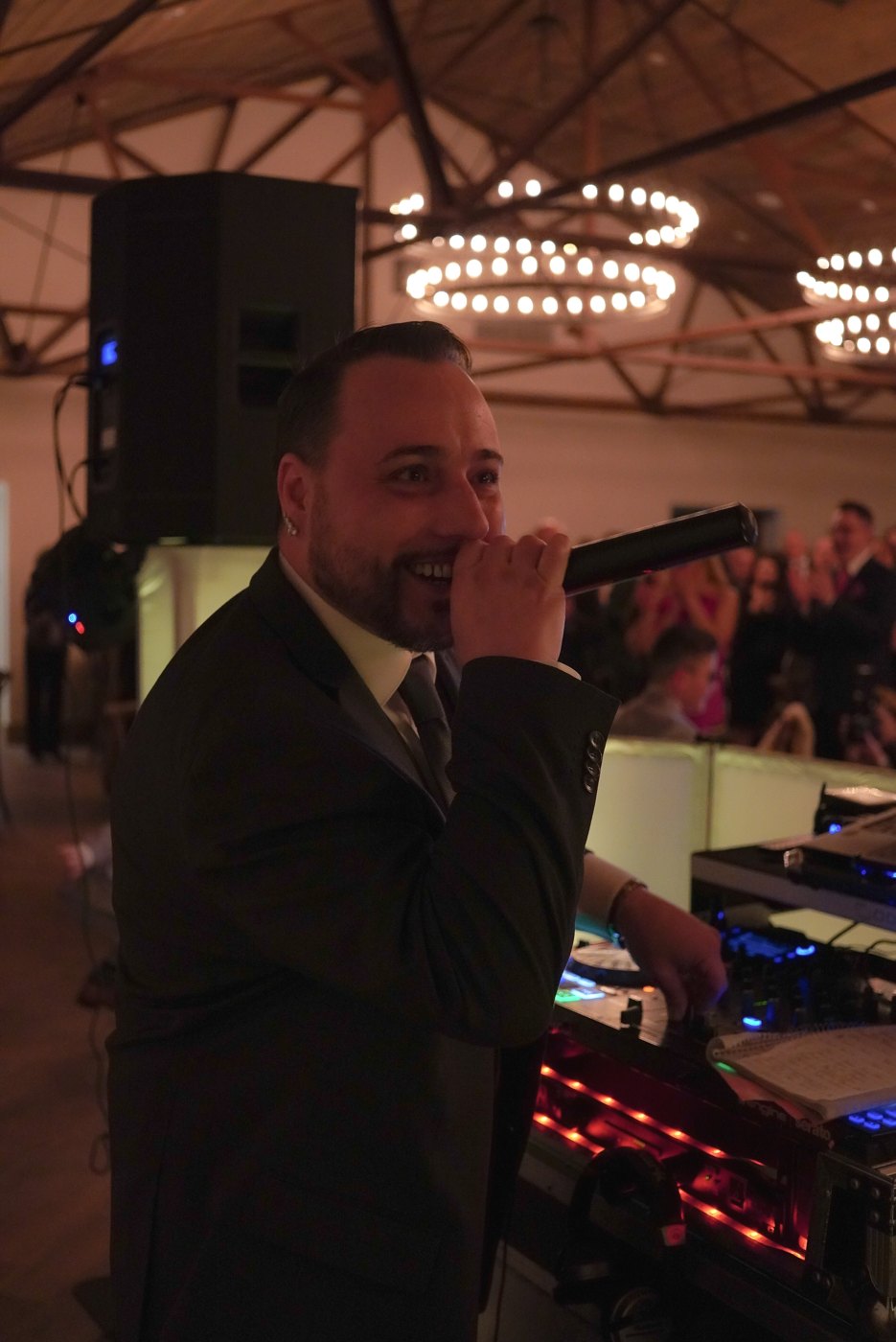 Barry smiling on the microphone at the DJ booth