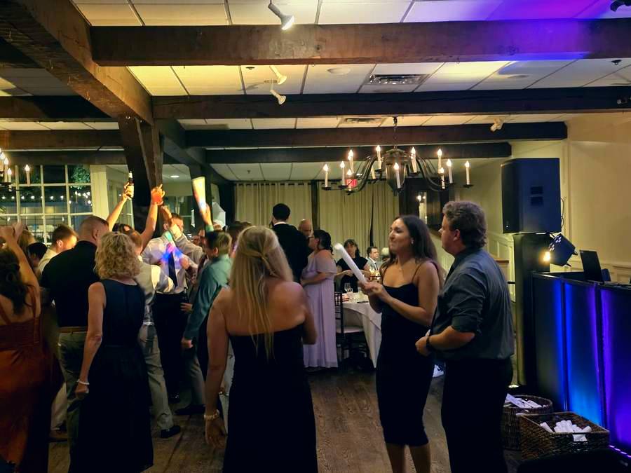 Wedding guests with hands up on the dance floor