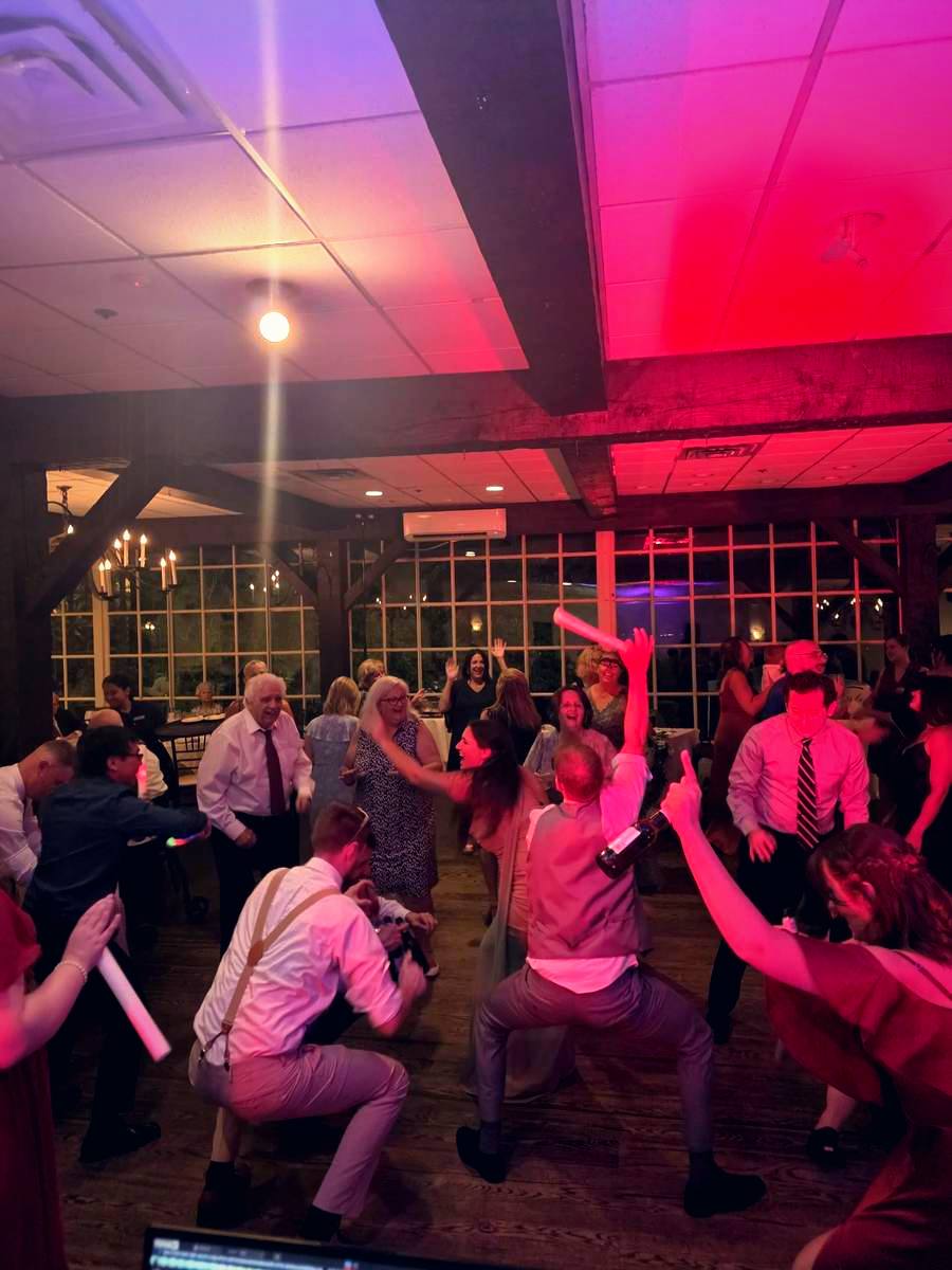 Guests dancing under red lights