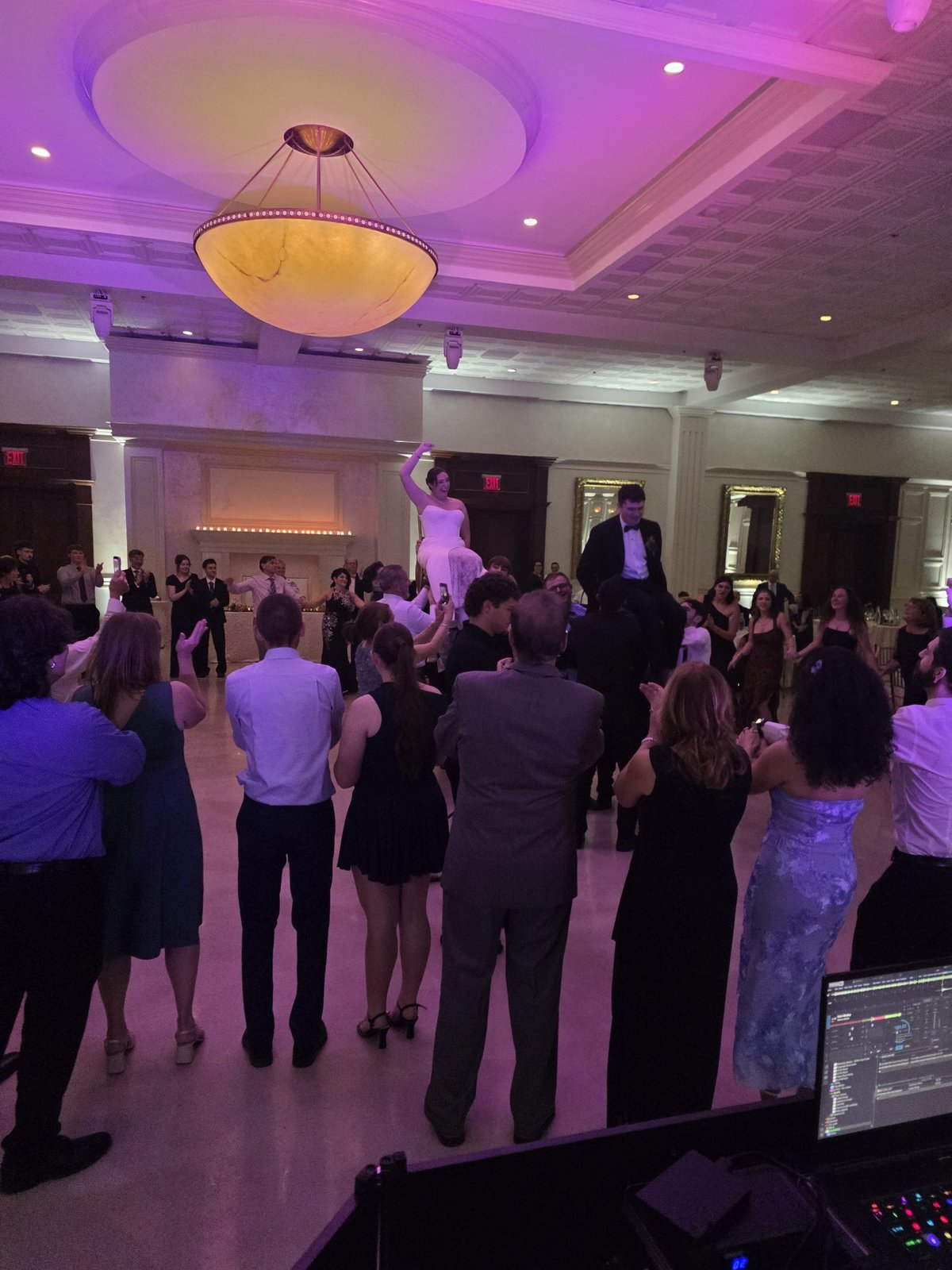 Bride lifted on chairs during the hora — Elana & Nick's wedding at South Gate Manor