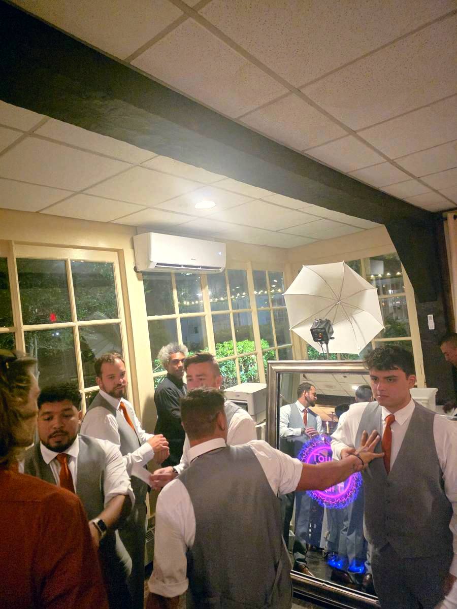 Groomsmen posing at the mirror photo booth