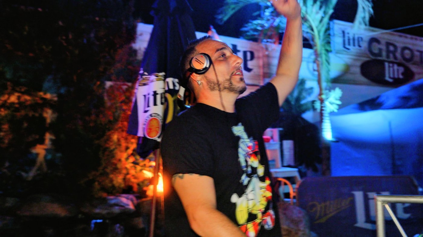 Barry with arm raised hyping the crowd at an outdoor night event