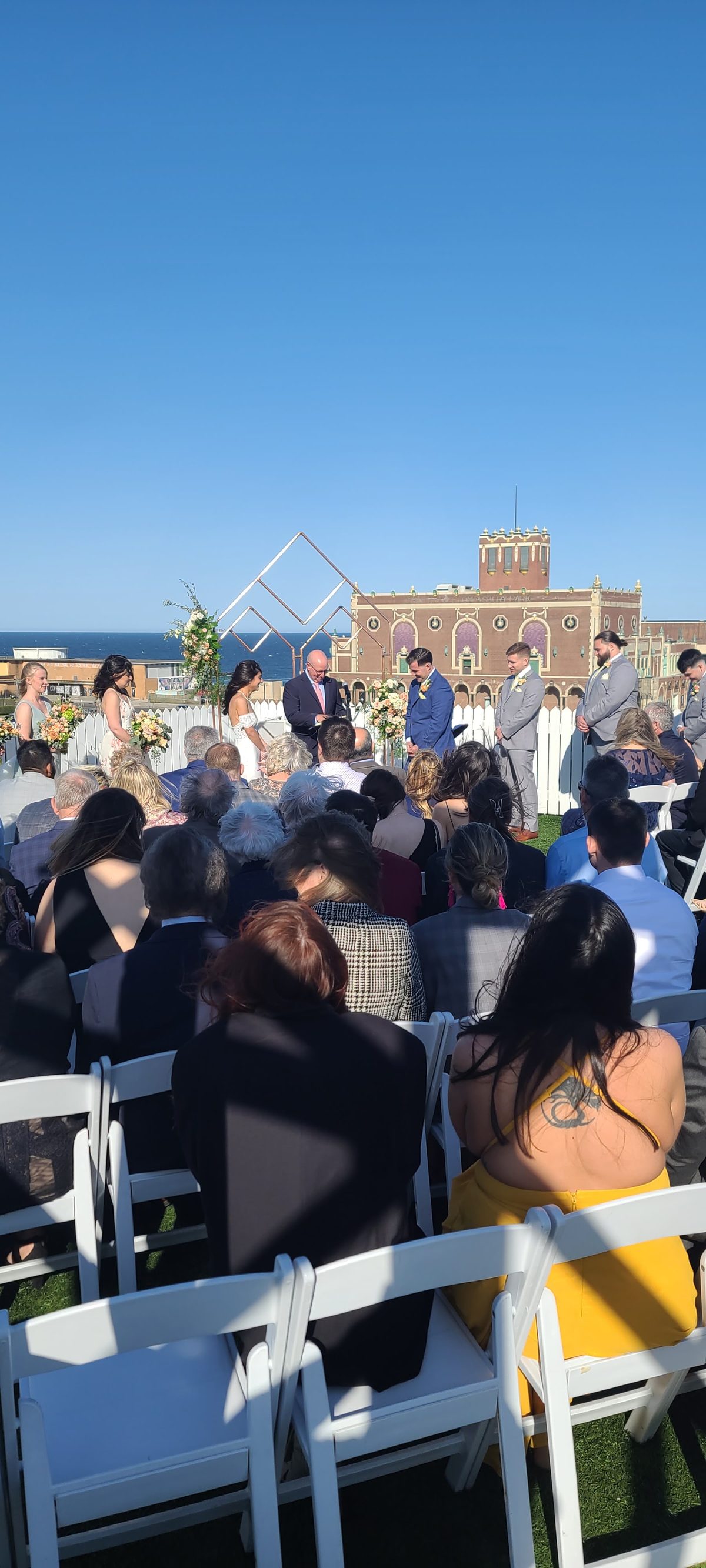Outdoor wedding ceremony in front of a grand hall