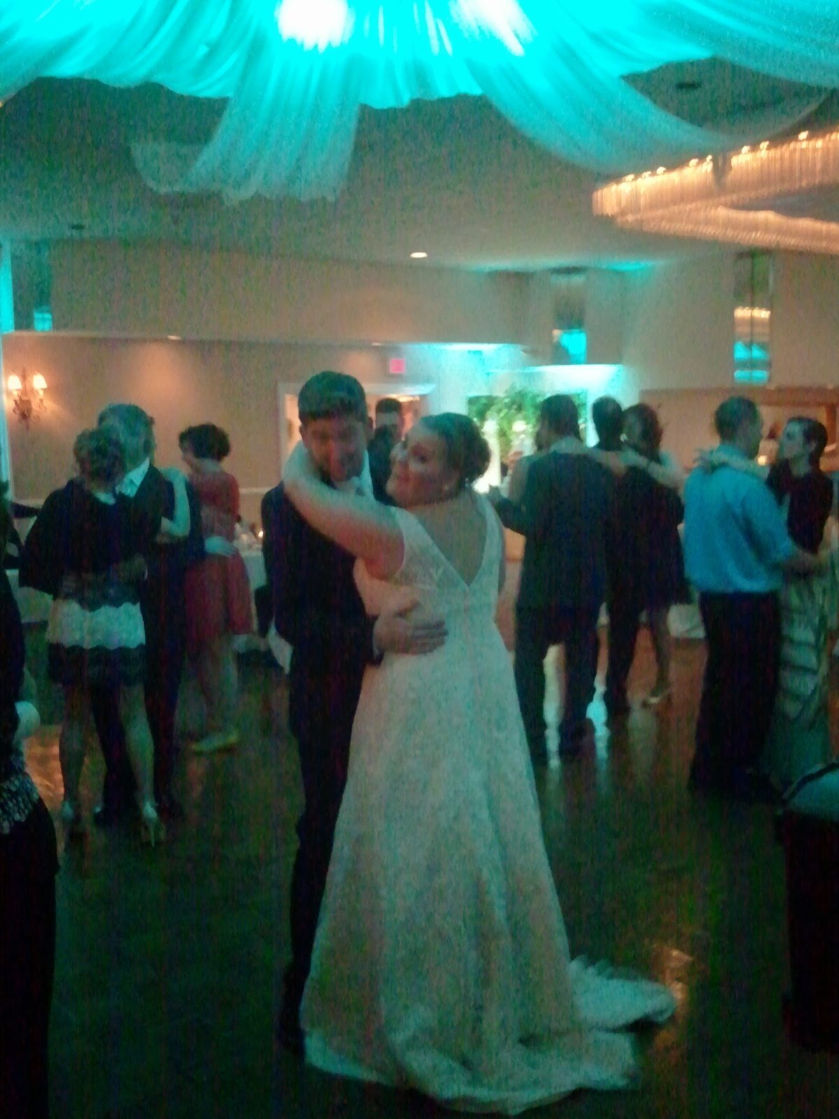 Couple's first dance under elegant lighting