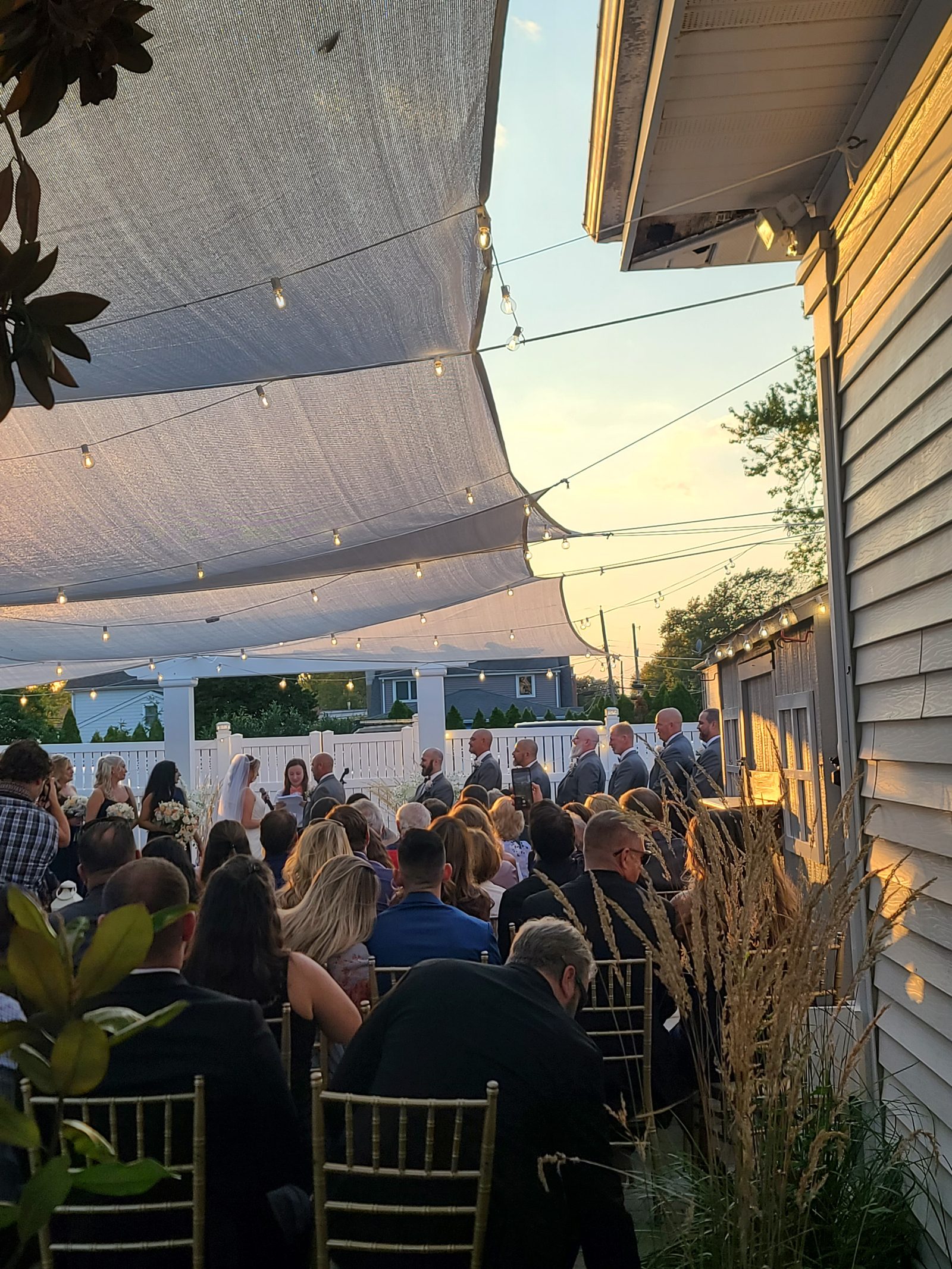 Tented outdoor wedding reception at golden hour