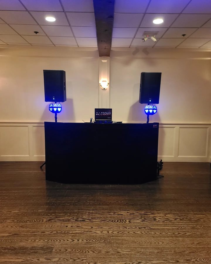 The Party DJ setup &mdash; black facade with two speakers and dance lights