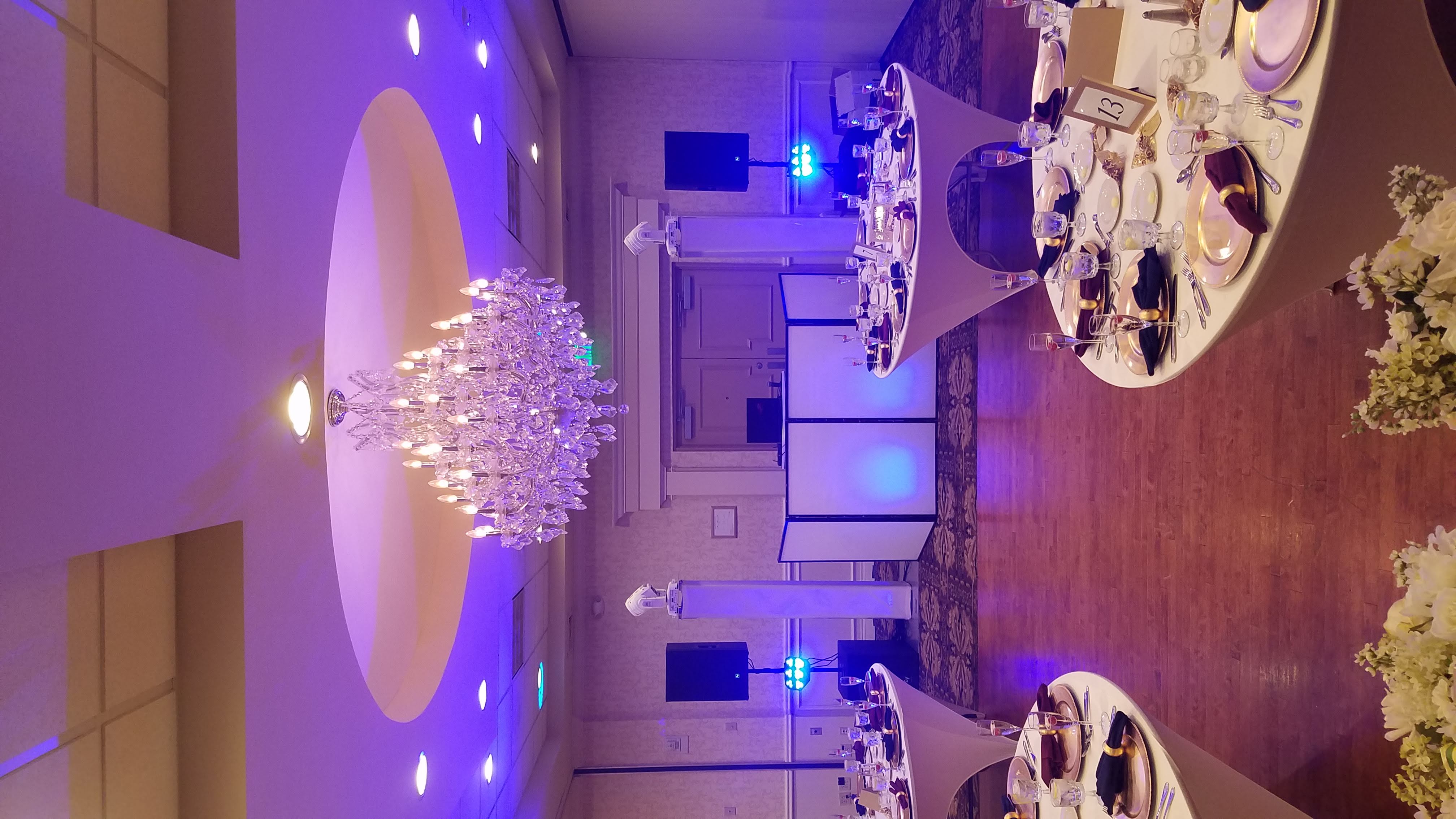 Grand ballroom with chandeliers and purple uplighting