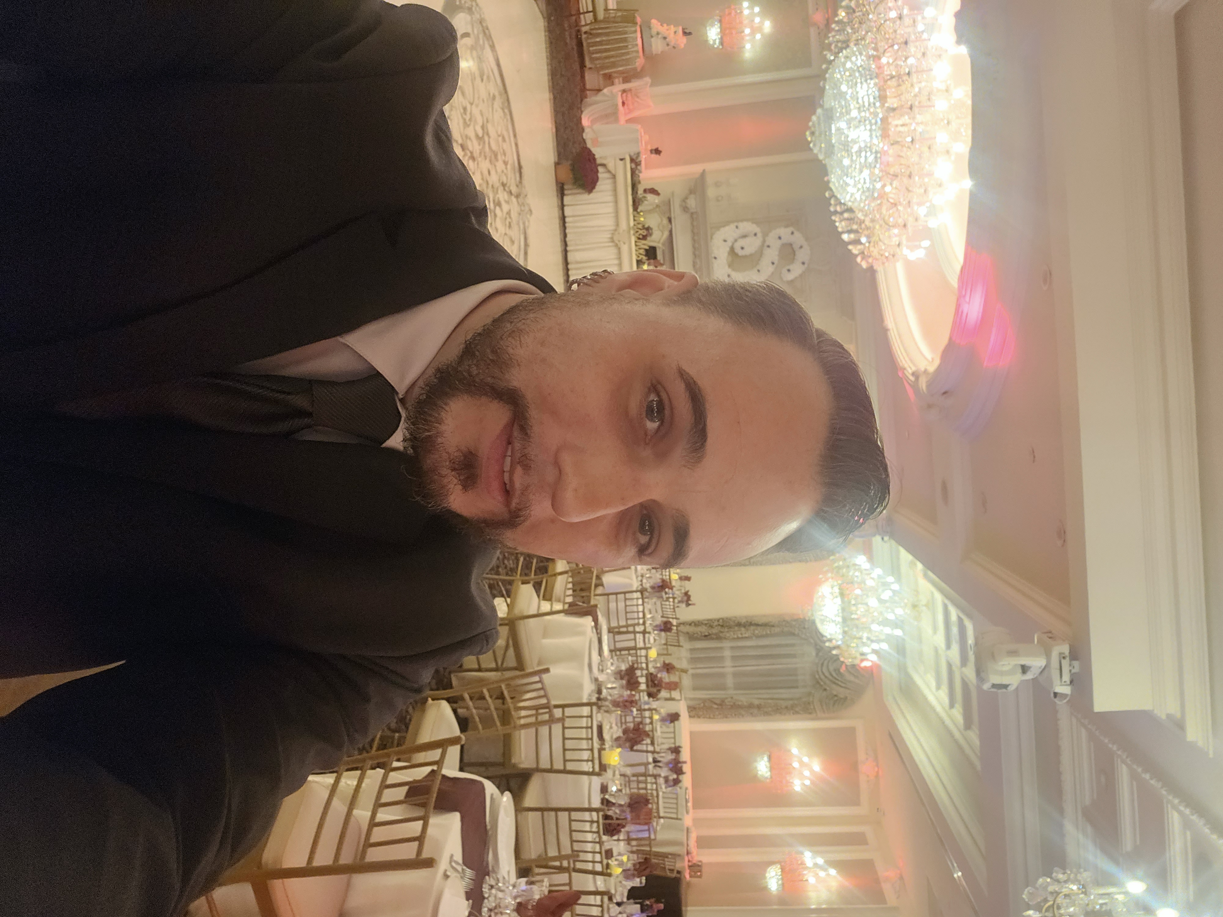 DJ Barry Proud in a suit at a wedding reception