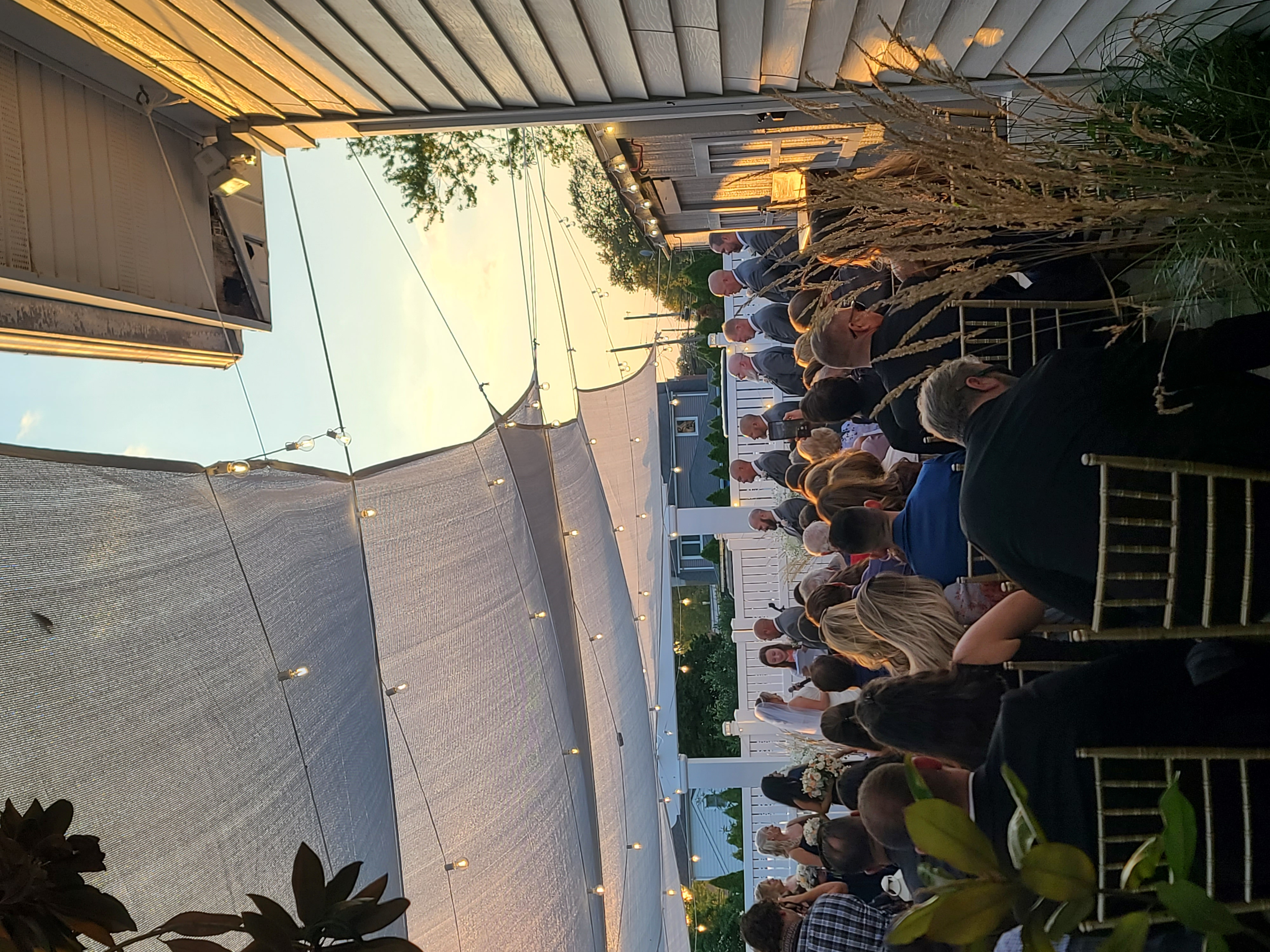 Tented outdoor wedding reception at golden hour